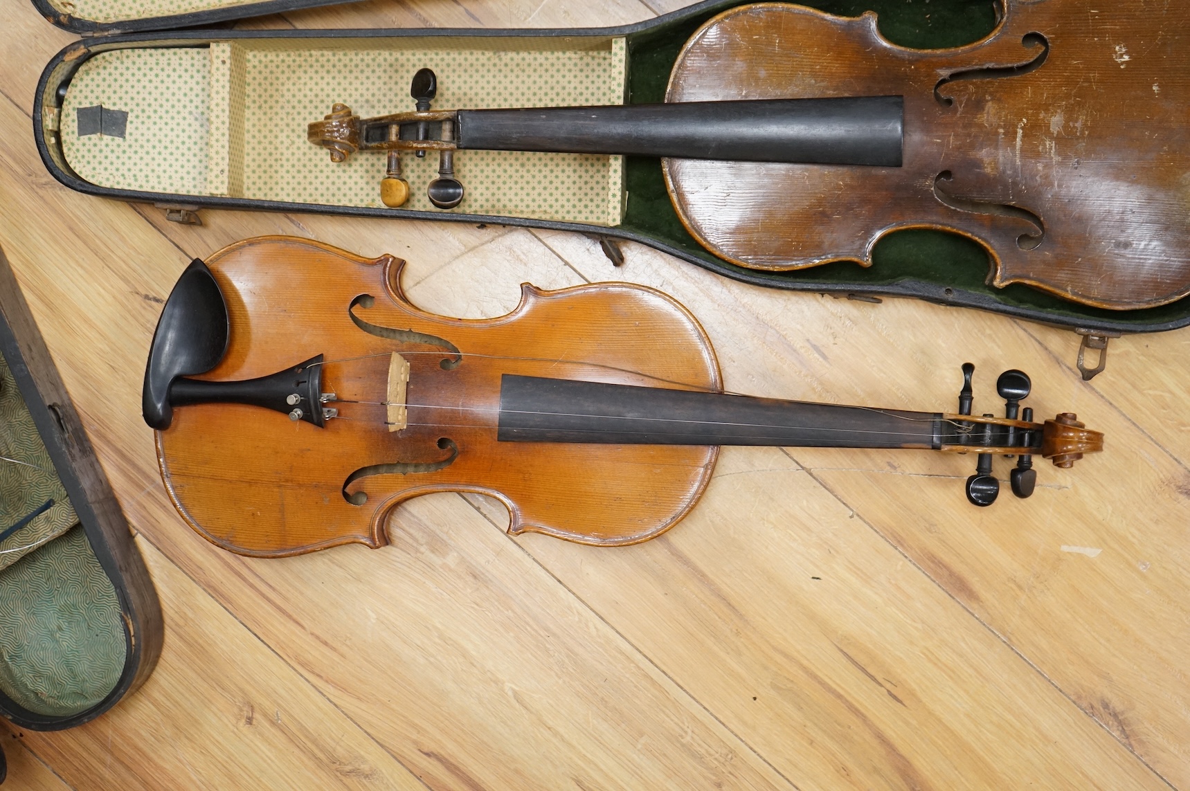 Four violins; a German Dresden violin, together with further two German violins, and a Saxony violin, three in cases or the remains of cases.